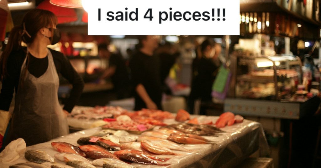 woman selling fish at a market