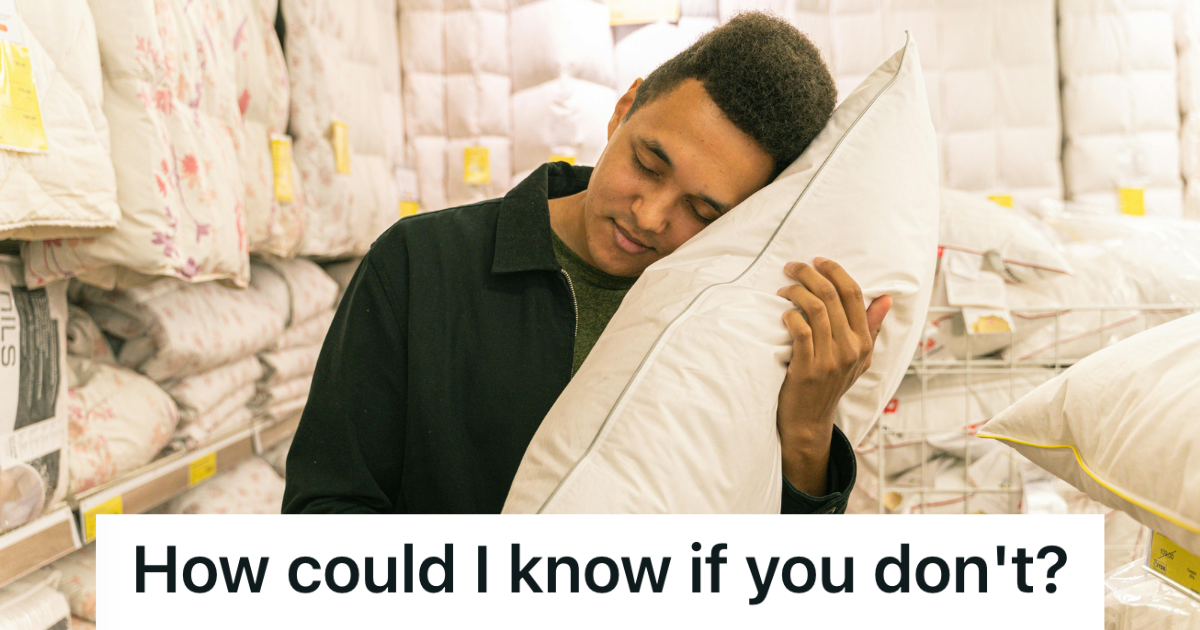 man hugging a pillow at the store