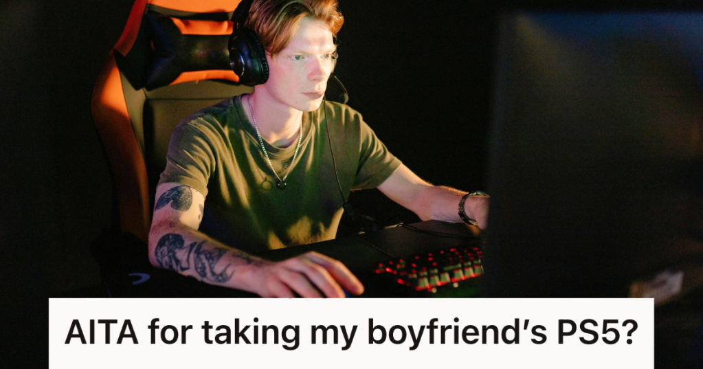 man playing video games in the dark