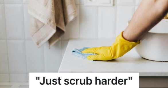person scrubbing kitchen counter