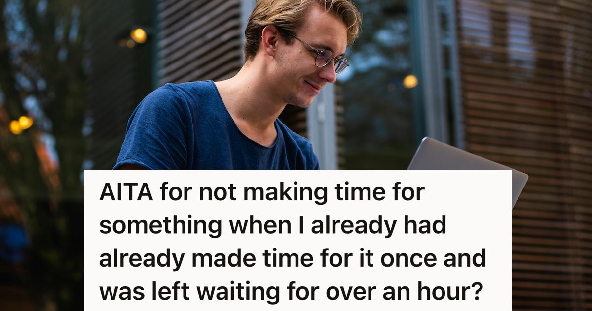 man smiling and looking at a laptop