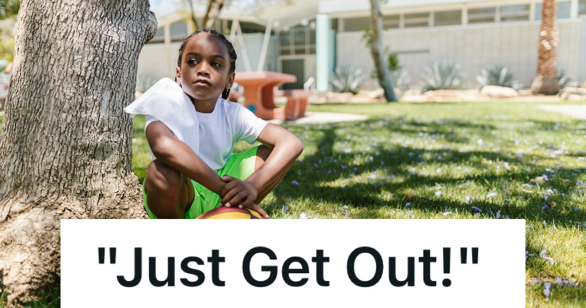 child sitting on the ground under a tree