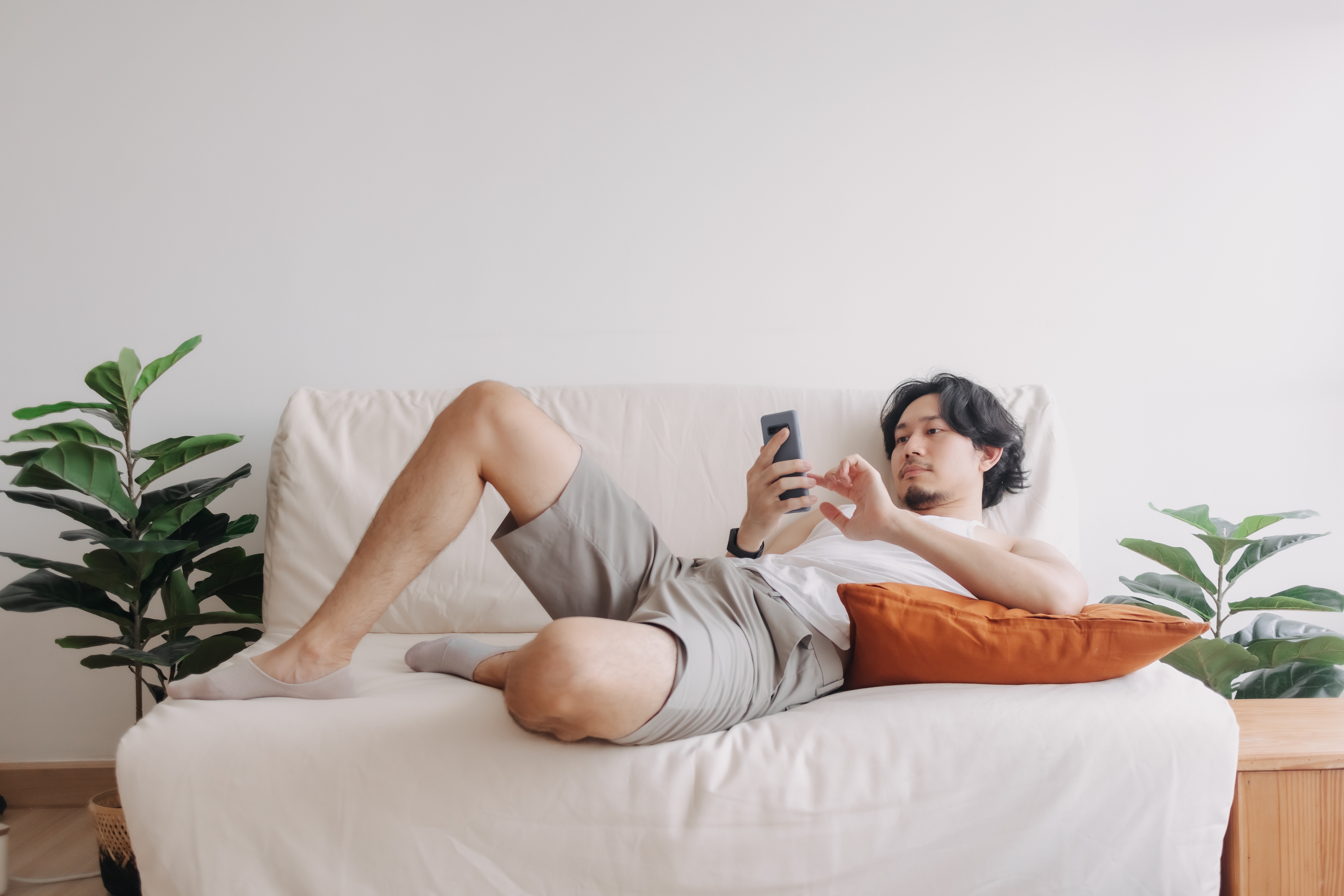 lazy man scrolling on phone