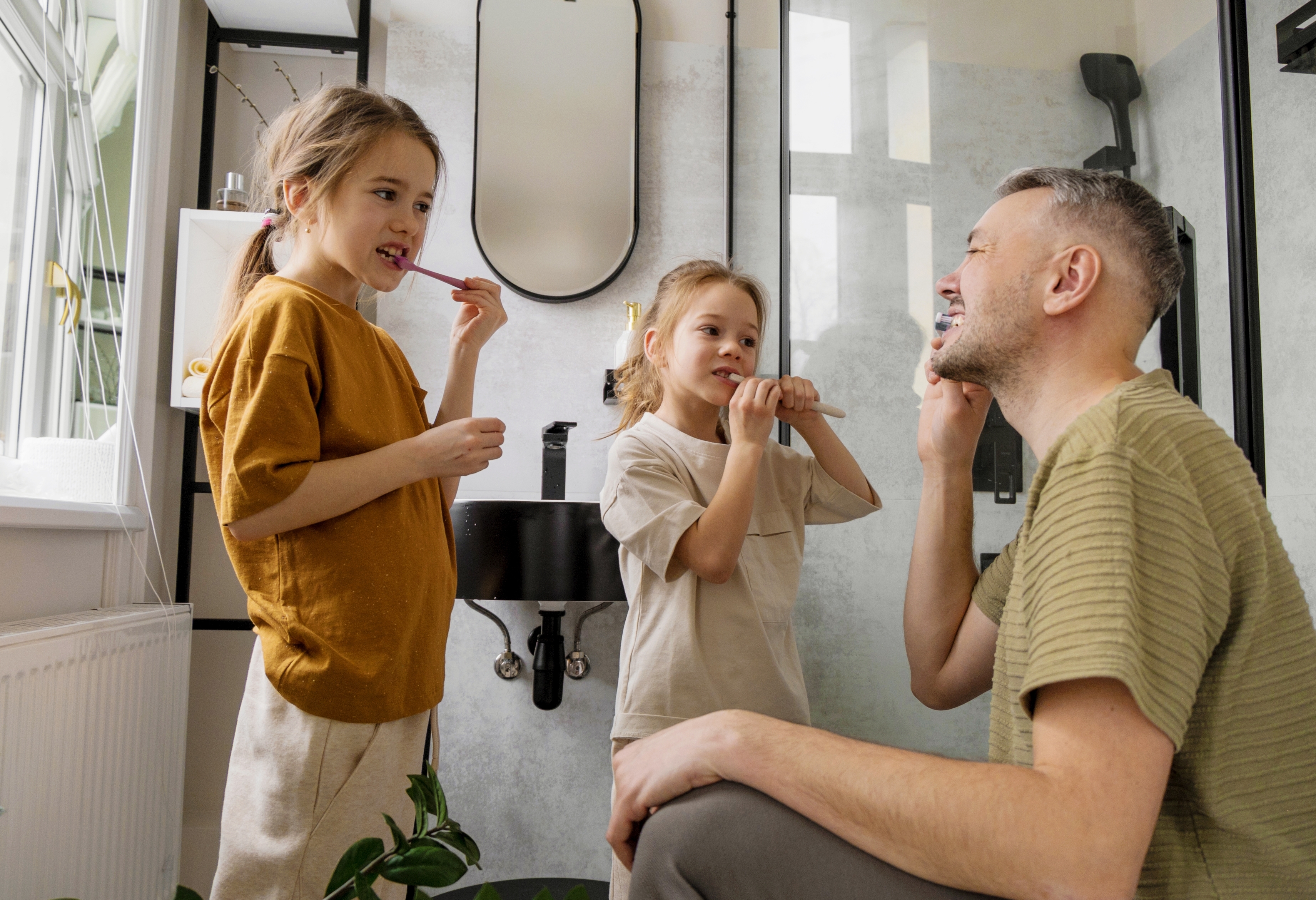 dad and kids brushing their teeth lead toothpaste