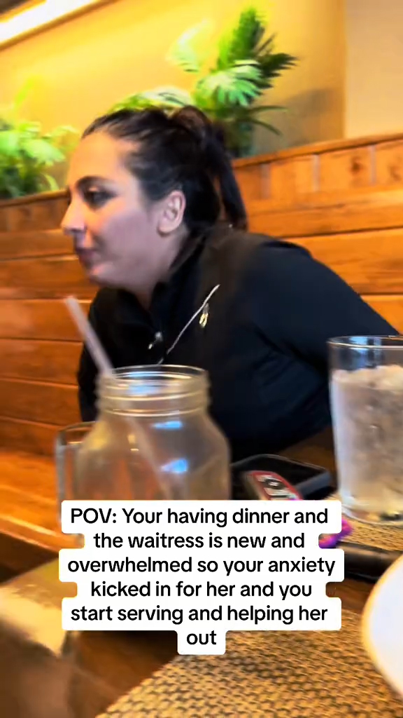 A woman filing in as a server in a restaurant