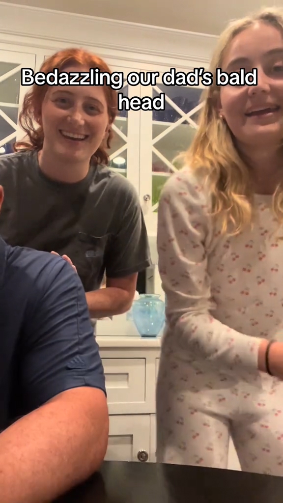 Two daughters bedazzling their dad's bald head