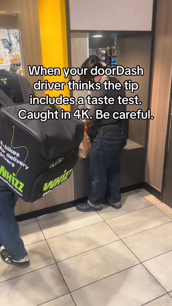 A DoorDash driver taking fries from a bag