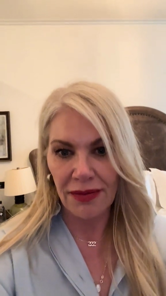 A woman in a hotel room with a creepy painting