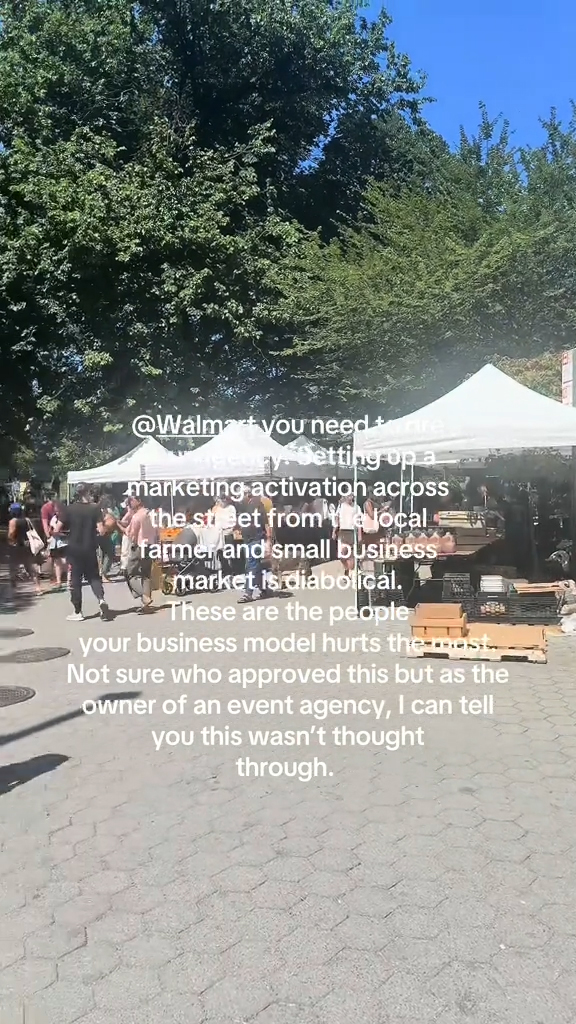 A Walmart booth set up across from a Farmer's Market