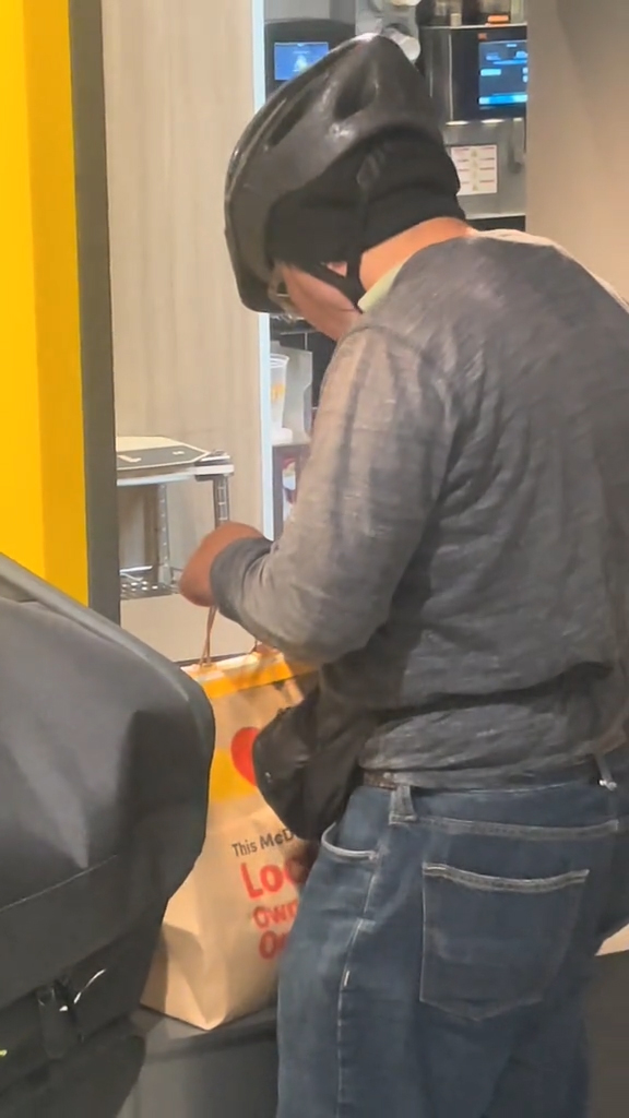 A DoorDash driver taking fries from a bag