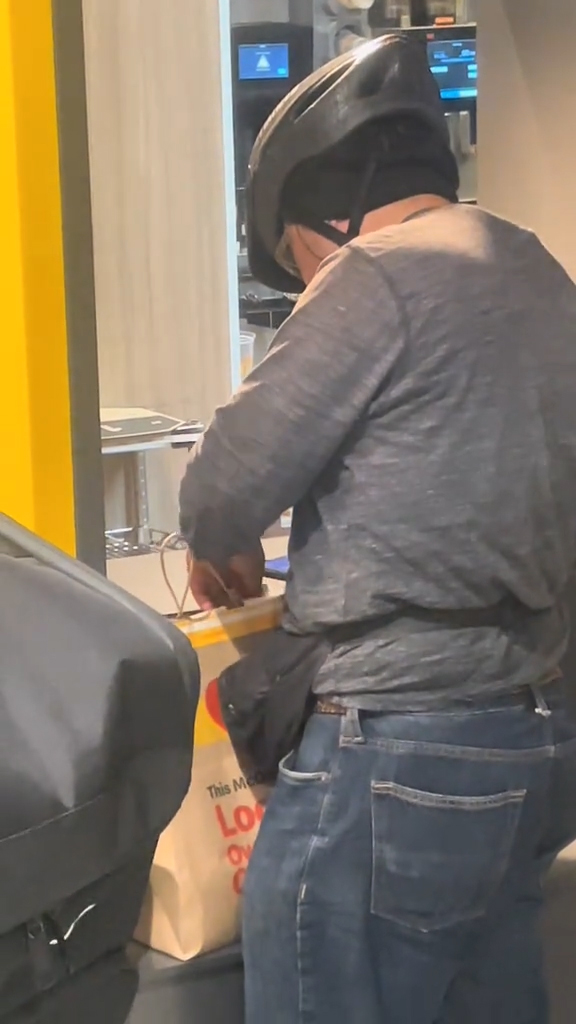 A DoorDash driver taking fries from a bag