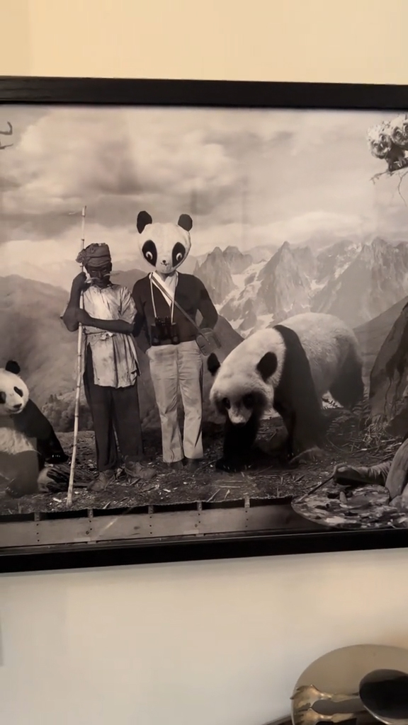 A woman in a hotel room with a creepy painting