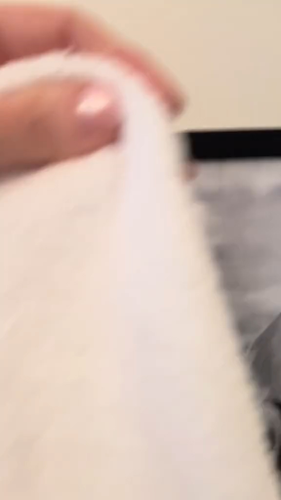 A woman in a hotel room with a creepy painting