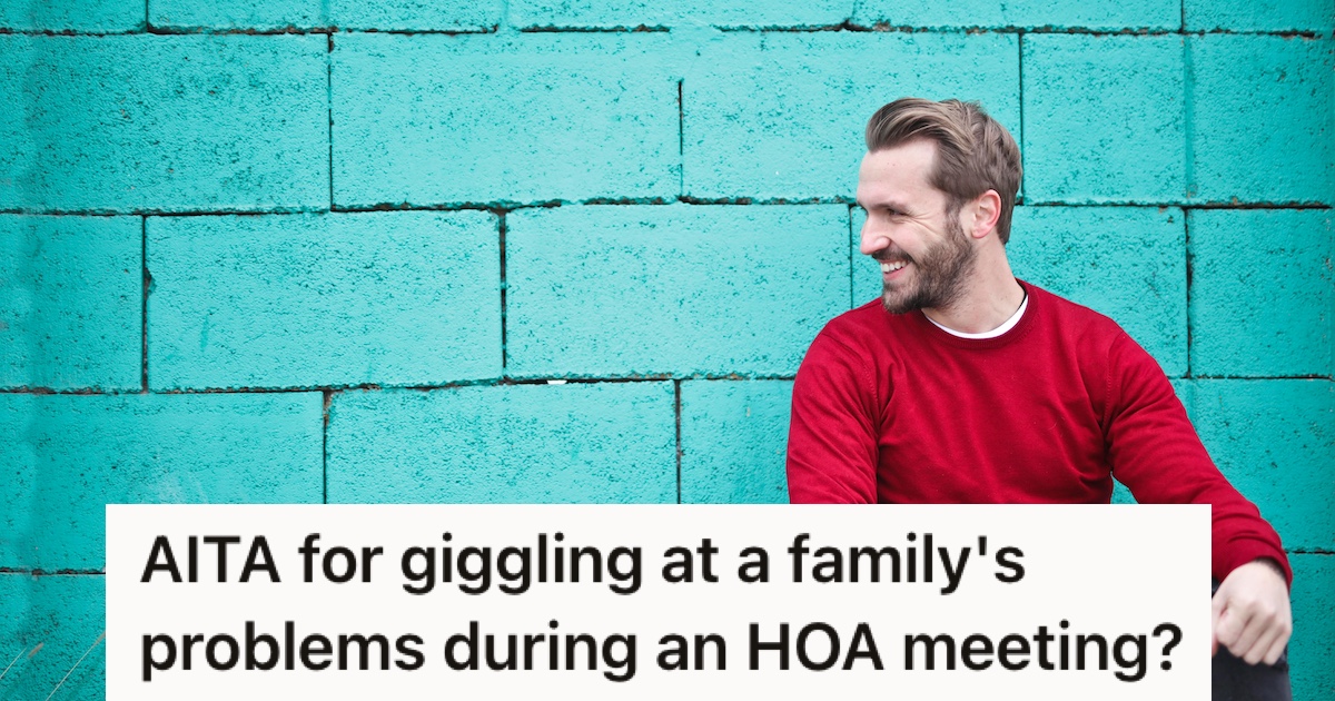 A man laughing against a turquoise wall