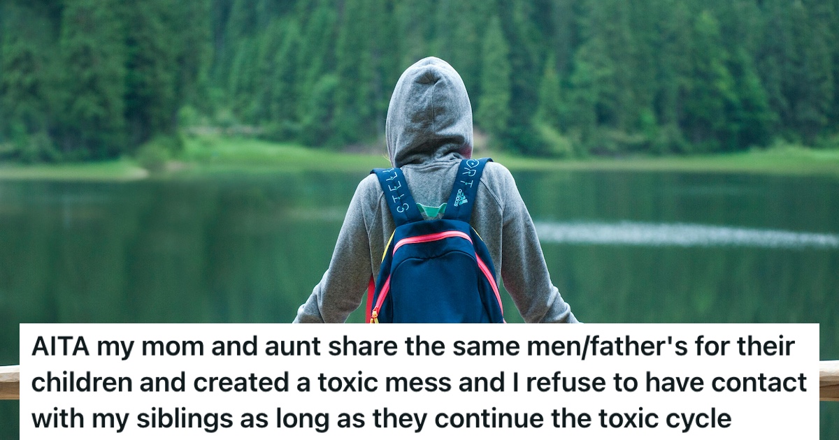 A person in a hoodie with a backpack, alone at a lake