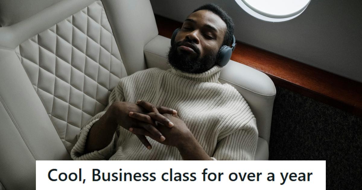 Man lying in business class listening to music on his flight to China