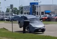 A Massive Speed Bump Forming Due To The Road Buckling As A Car Launches Over It Is Caught On Tape