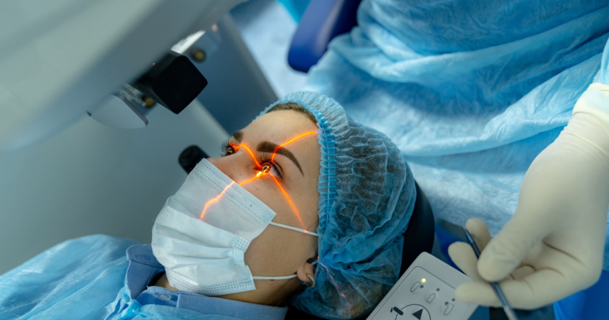 Doctor with lasers in patients eyes