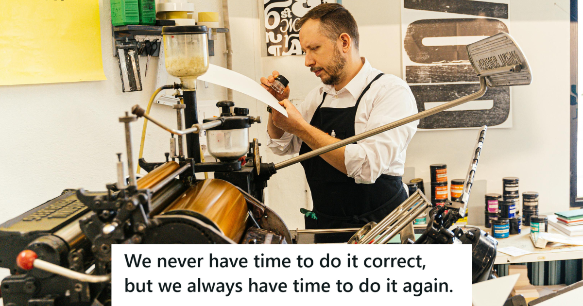 Man in black apron working at a printing press