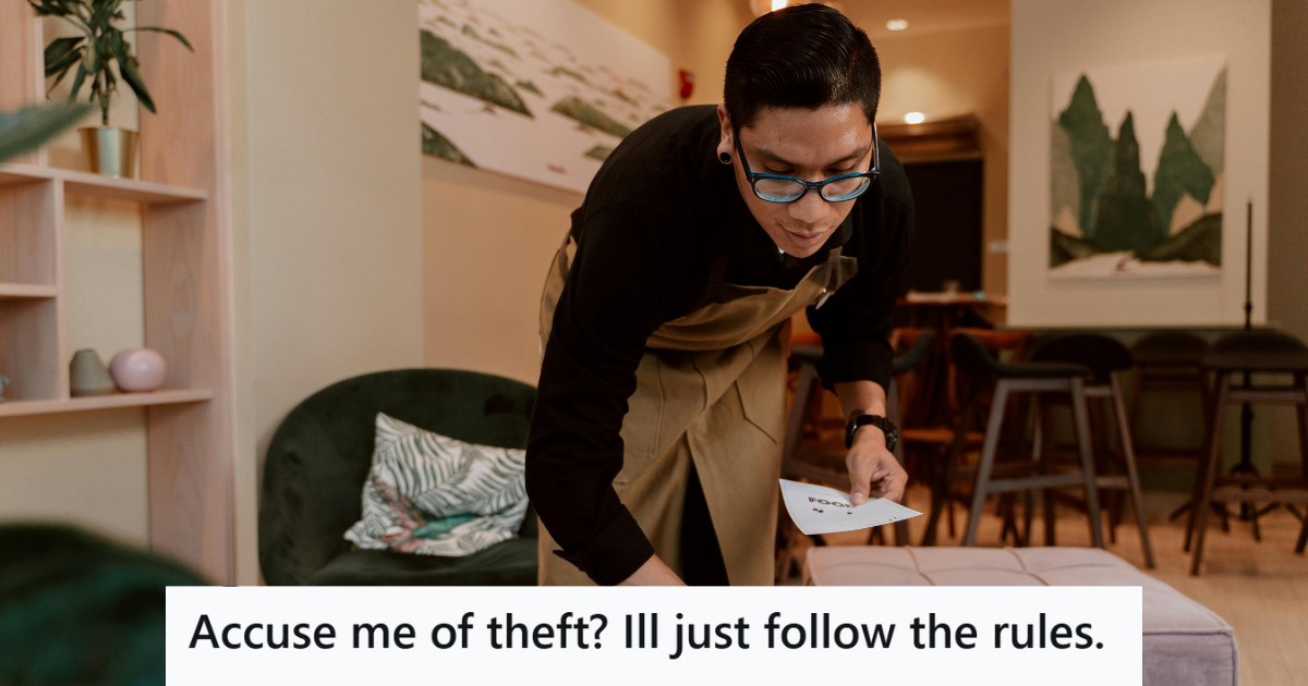 Man in apron cleaning a table