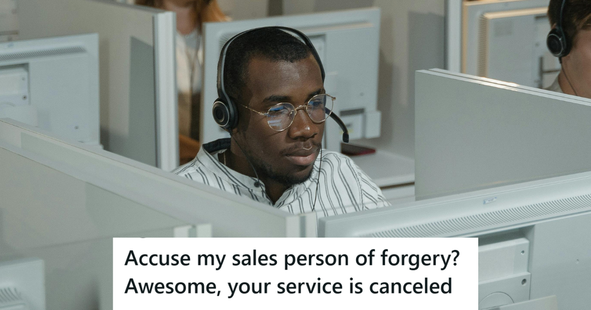 Man in a white cubicle wearing a headset.