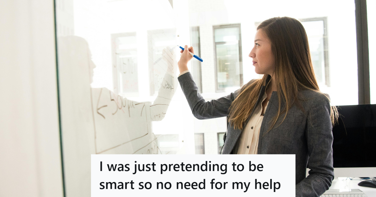 Teacher in a suit writing on a white board
