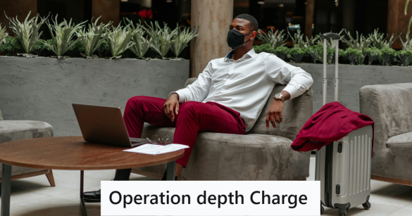Man in red pants sitting with laptop in a lobby