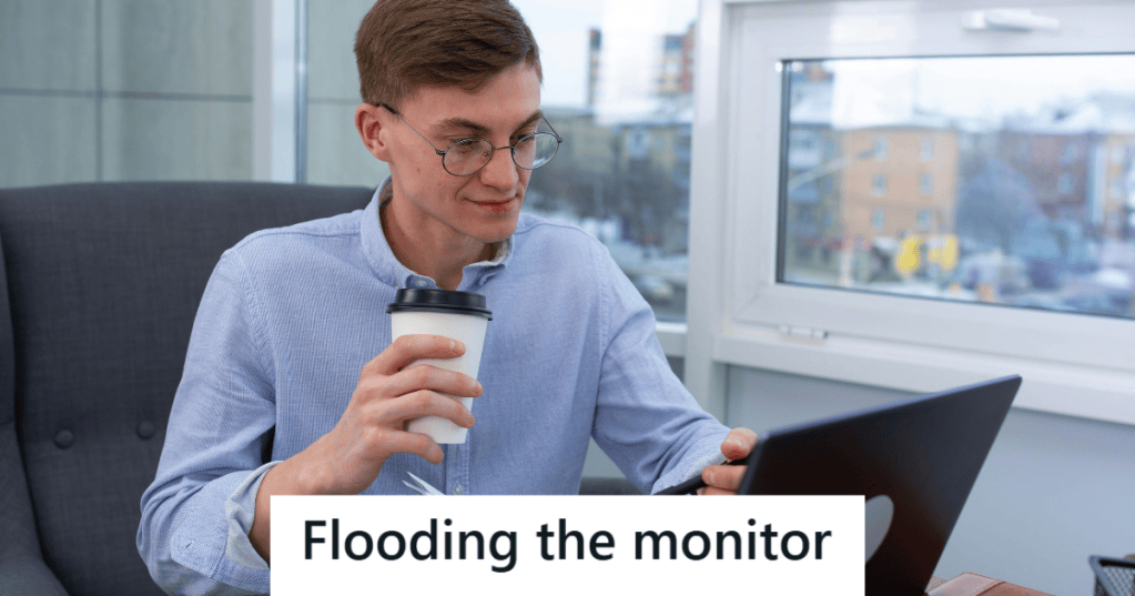 Man in blue shirt sipping coffee and working