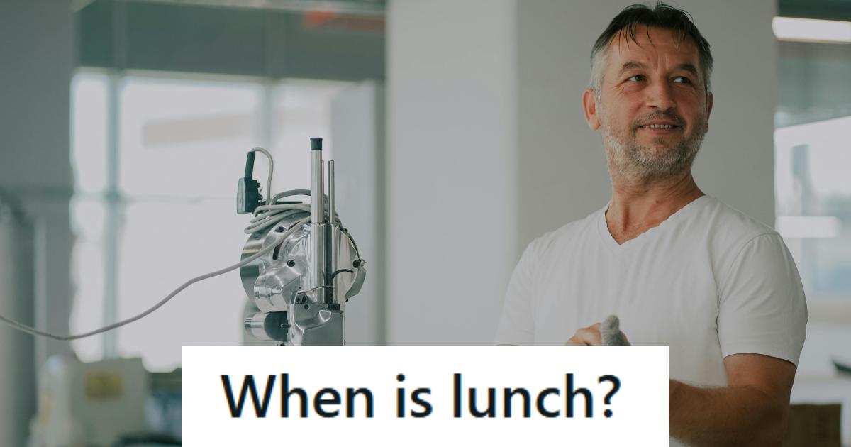 Man putting on gloves to fix a machine but being interrupted by the manager