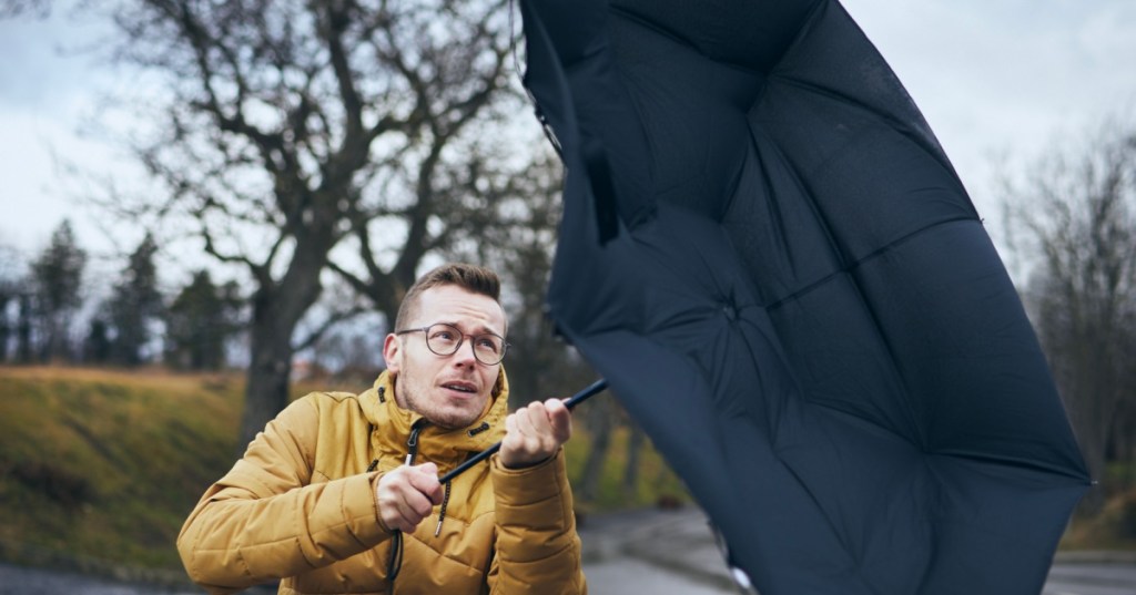 Windy weather with umbrella