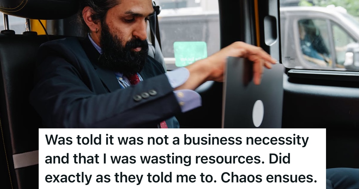 Man sitting in a car working on a laptop