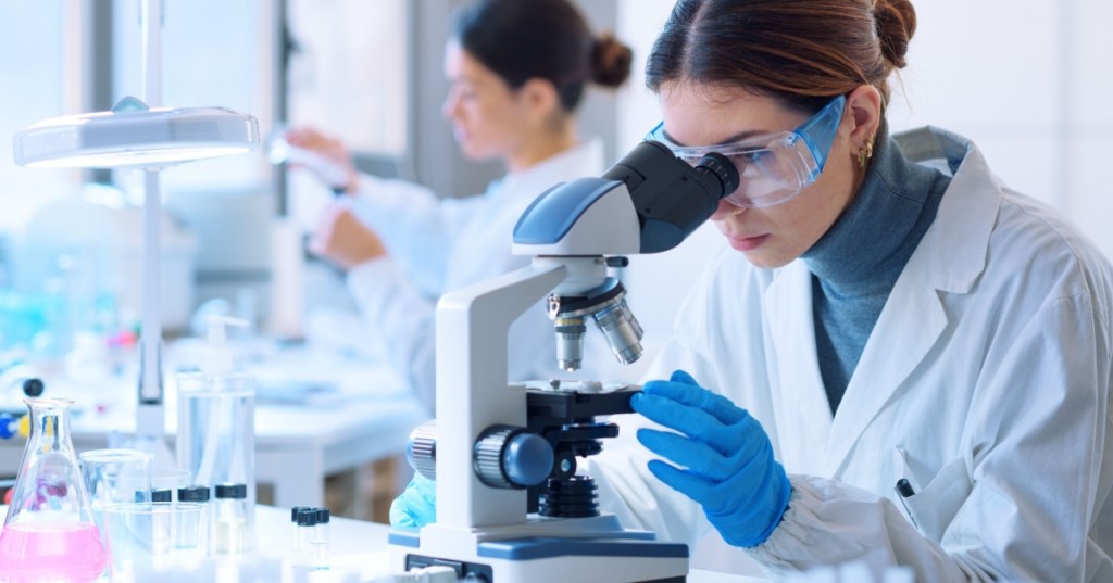 Researcher looking in microscope