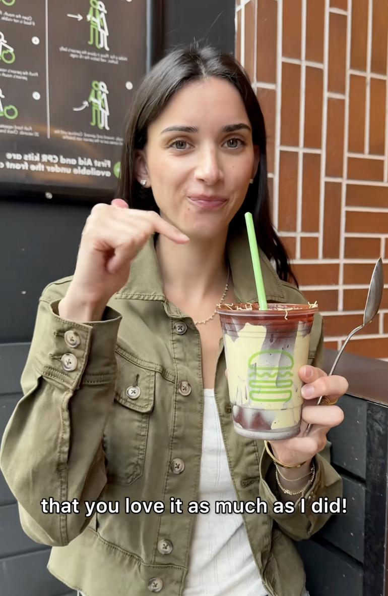 woman holding a milkshake
