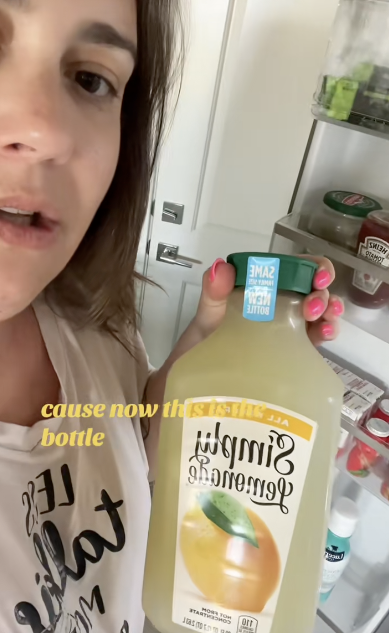 woman holding a bottle of lemonade
