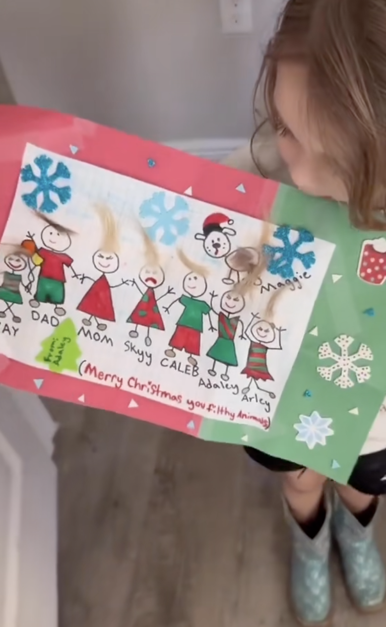 girl holding art project