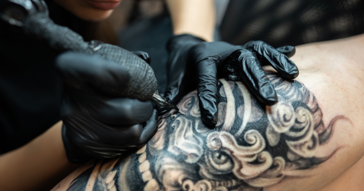 Tattoo artist working