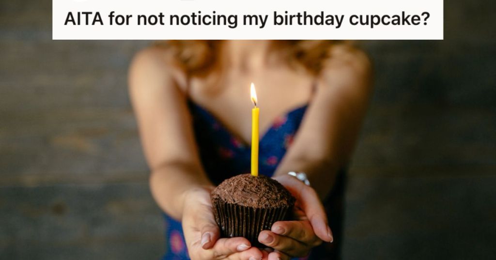 Woman holding a cupake with lighted candle