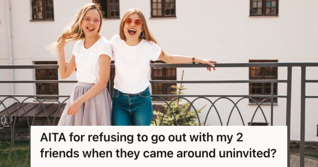 Two girls posing and smiling outside an apartment building