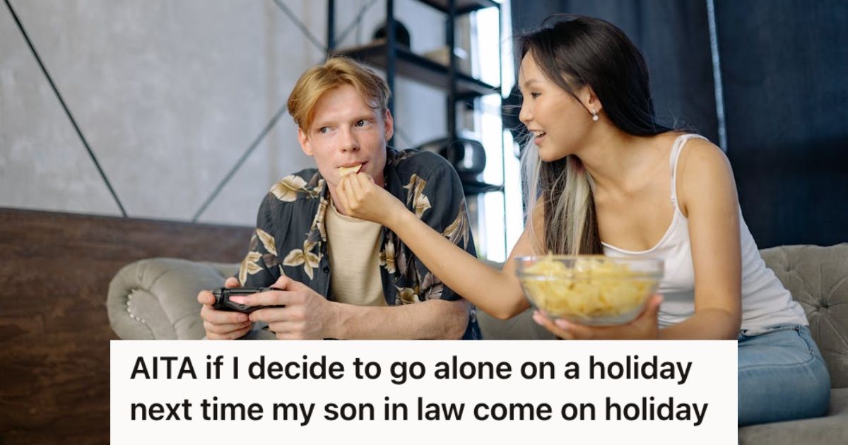 Man playing video game while woman feeds him some chips