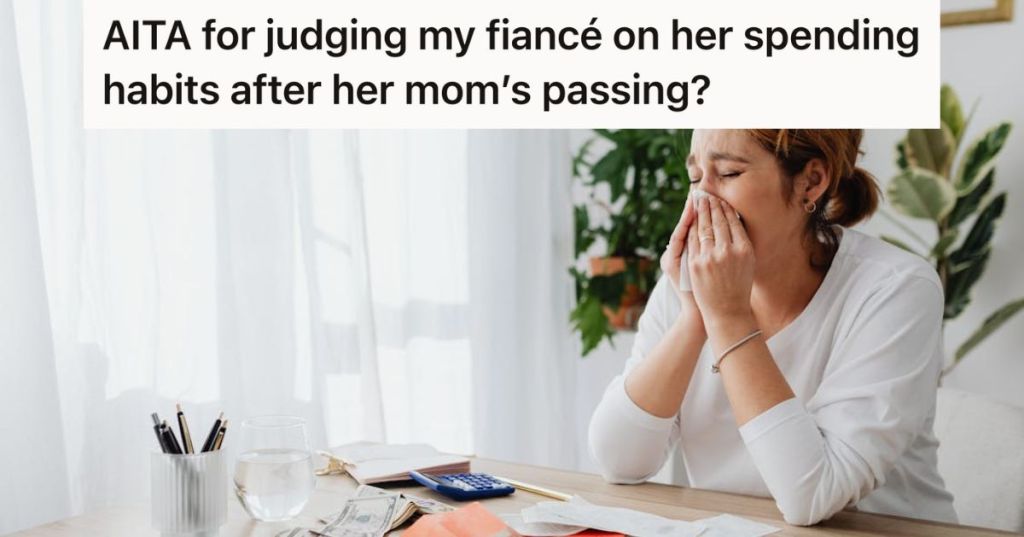 Woman crying with bills and money on her desk