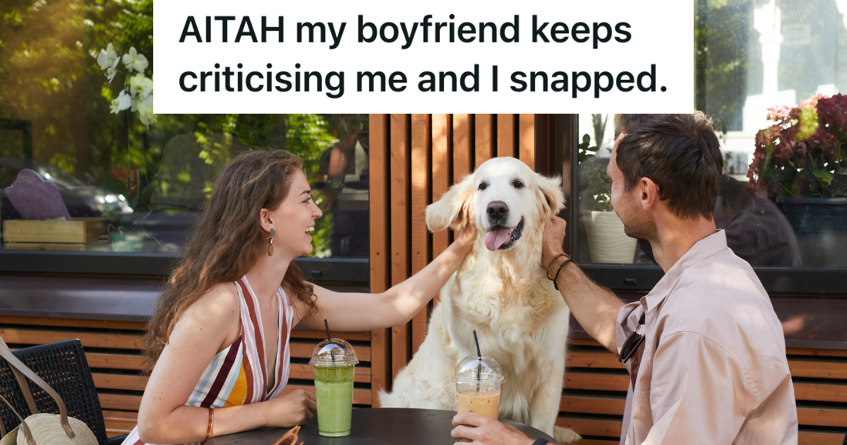 couple sitting at a cafe table with their dog