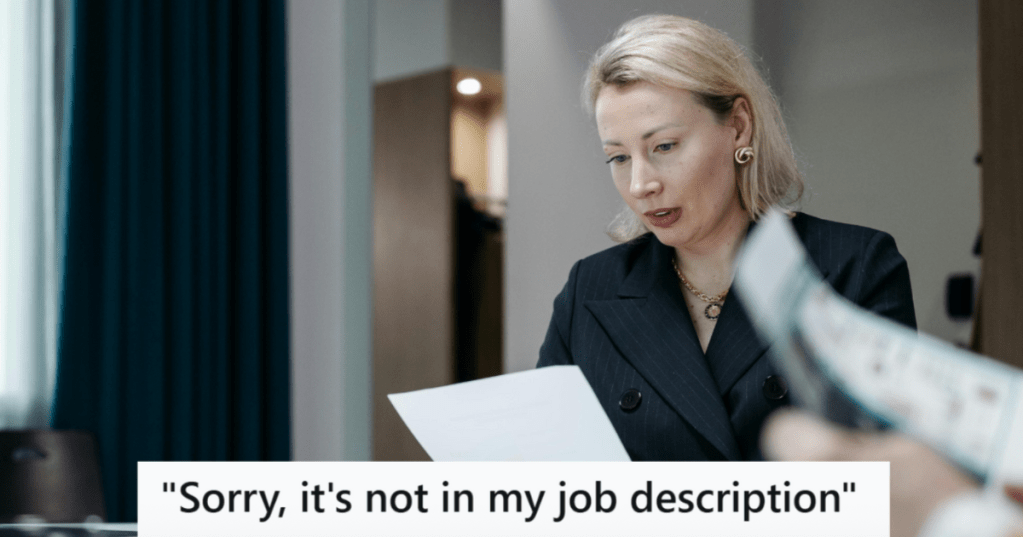 Lady in black suit sitting at a desk and reading a paper