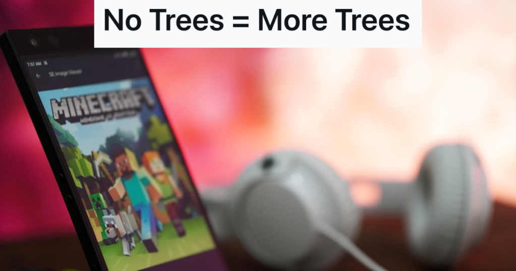 Minecraft logo on a phone next to white headphones