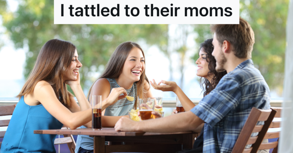 four happy teenagers talking at a restaurant table