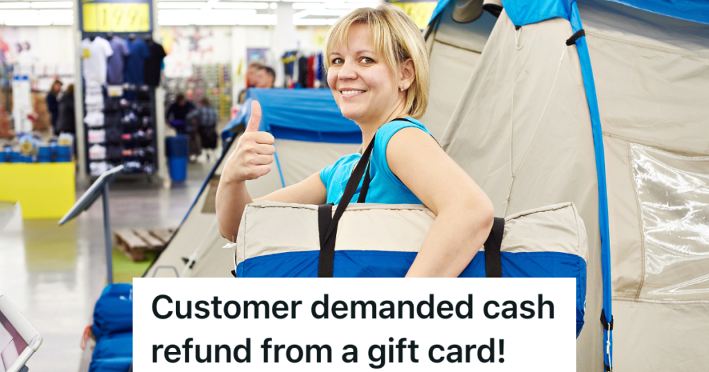 smiling woman gives thumbs up while holding a folded up tent