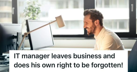 Man smiling, looking at his computer screen
