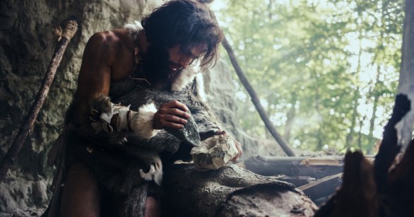 Cave man carving something
