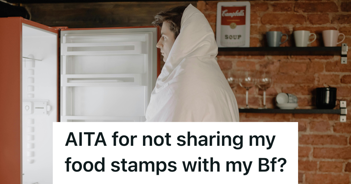 man looking in an empty fridge