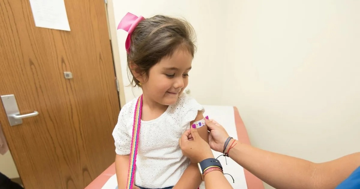 A child smiling after a vaccination