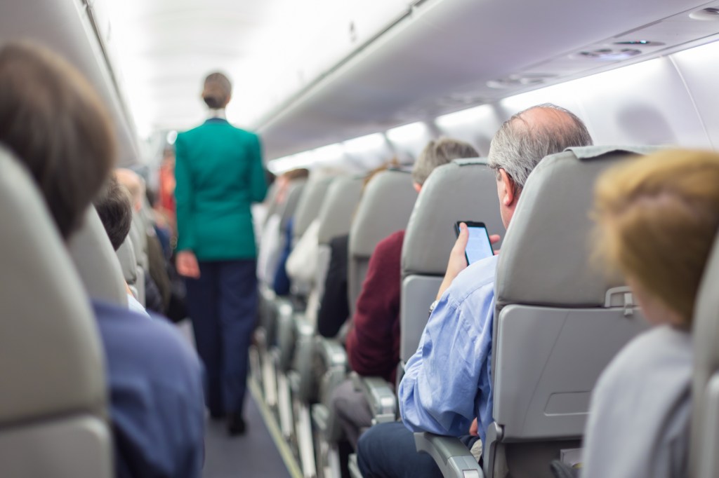flight attendant walking aisle